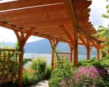 Pergola tarasowa drewniana jak zrobić? Piękny widok na jezioro i góry spod zadaszenia.
