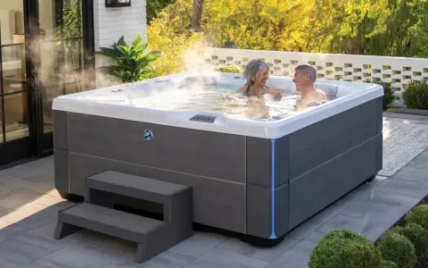 Para relaksu w ogrodzie: para cieszy się kąpielą w jacuzzi. Dowiedz się, jak zabudować jacuzzi ogrodowe, by stworzyć idealne miejsce wypoczynku.